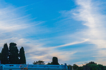 Fototapeta premium Traces of airplanes spread across the sky, stretching over huge distances, concept about the impact of the climate change program on nature