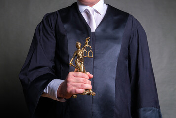german lawyer with a robe holding a statue of Lady Justice