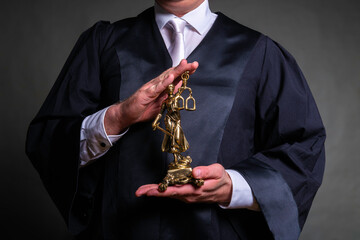 german lawyer with a robe holding a statue of Lady Justice