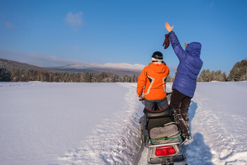 A snowmobile ride in the mountains of the Southern Urals. Athletes take pictures of beautiful...
