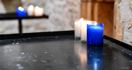 rows of prayer candle votive lit in the church chapel