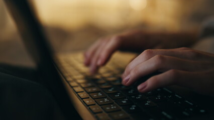 Hands typing keyboard night closeup. Late manager freelancer working computer
