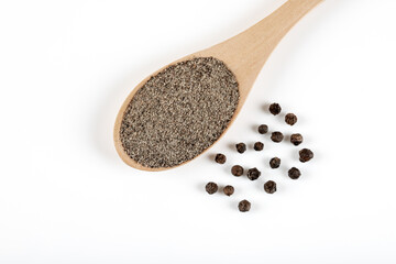 Ground black pepper with grains of black pepper on white background
