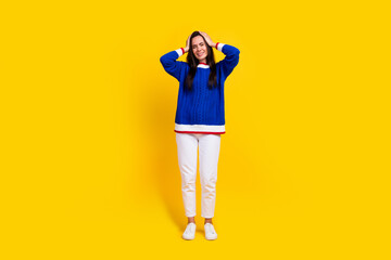 Full length size photo of depressed lady in blue jumper hands touch head close ears avoid loud sounds isolated on yellow color background