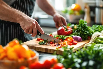 Fotobehang vegetables getting chopped on a desk in bright kitchen  © Straxer