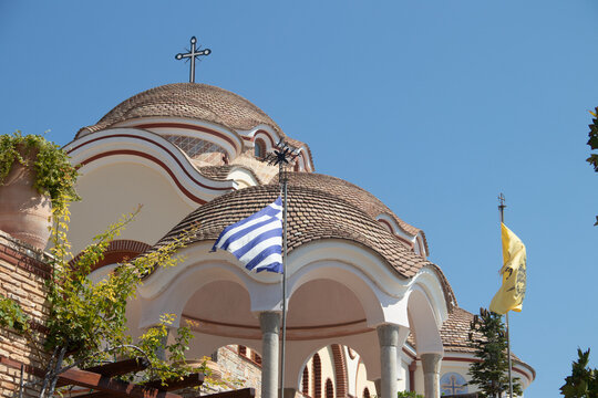 View on backyard of Monastery of Archangel Michael in Greece, Thasos Island, with vivid orange walls and roof, monastery was build at the cliff over the Aegean Sea, which first began as a men's only 