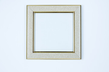 The frame is light, silver, the frame is white with gold edging on a white background. - obrazy, fototapety, plakaty