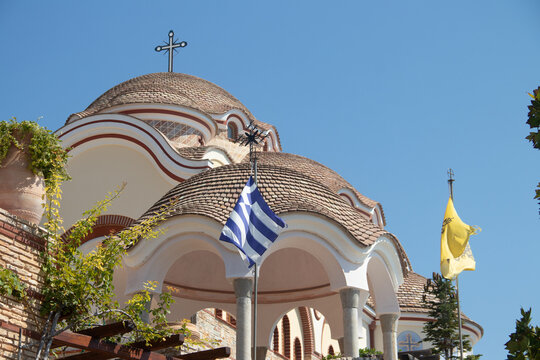View on backyard of Monastery of Archangel Michael in Greece, Thasos Island, with vivid orange walls and roof, monastery was build at the cliff over the Aegean Sea, which first began as a men's only 