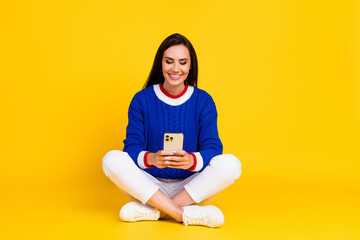 Full body photo of optimistic mature addicted user smartphone woman sitting floor surfing social...