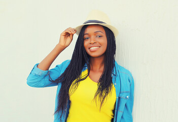 Portrait of stylish young african woman with dreadlocks posing wearing casual in the city