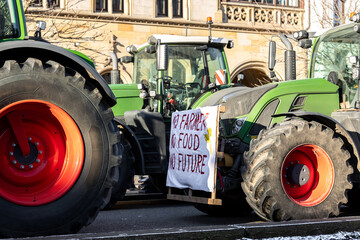 Farmers union protest strike against government Policy in Germany Europe. Tractors vehicles blocks city road traffic. Agriculture farm machines Magdeburg central Breiter weg street