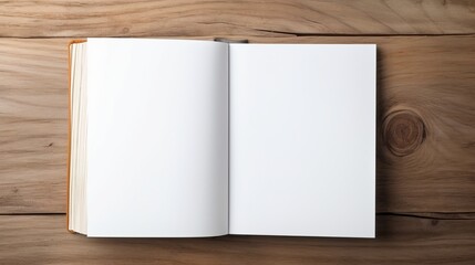 Top view of open blank white book on wooden table.