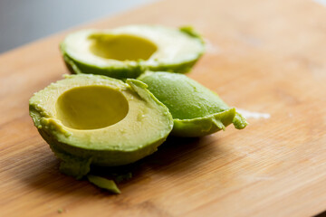 Cut in Half Avocado Close Up on Wooden Board - Fresh and Nutrient-Rich Delight