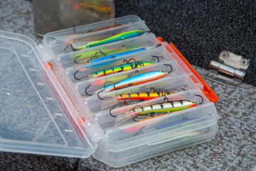 Fishing tackles and fishing baits in box .Classic Colored Fishing Lure , Beautiful Background...