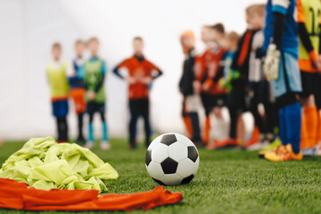 European football training at school. Group of school kids standing in row at physical education class. Young boys in sport practice during winter season