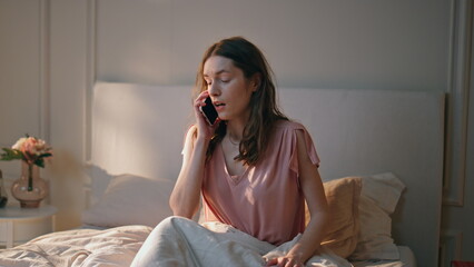 Anxious girl talking phone in morning. Stressed female oversleep work interview