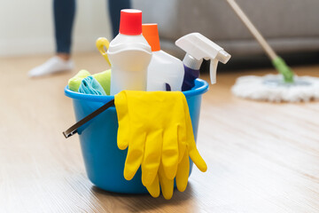 happy Female housekeeper service worker mopping living room floor by mop and cleaner product to...