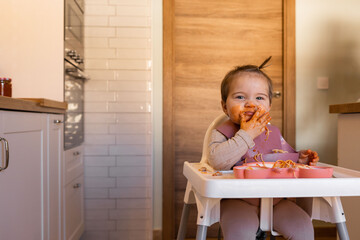 baby girl practice eat food by her self, Baby-Led Weaning concept