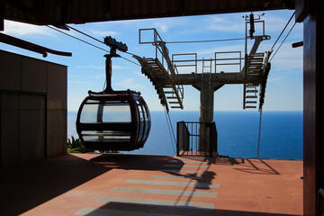 Cable-car gondola at the upper station of the Cristo Rei cableway on the Cape of Garajau in Caniço...