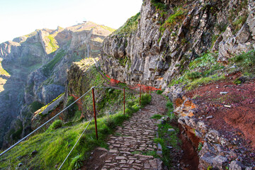 Walking trail at the Pico do Arieiro mountain peak on Madeira island, Portugal - Paved footpath for hikers visiting the third highest mountain of the island