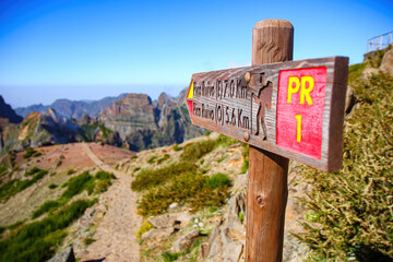 Signpost pointing at the Pico Ruivo from the Pico do Arieiro mountain peak on Madeira island,...