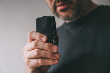 Man holding voice recording device