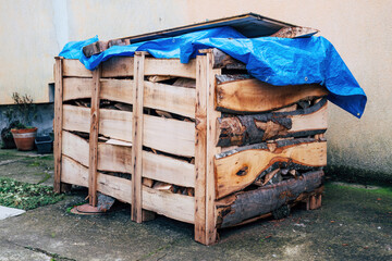 Stacked firewood in wooden crate box