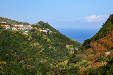 Fototapeta na wymiar Hillside traditional houses in Boaventura, a village in a valley of the north coast of Madeira island (Portugal) in the Atlantic Ocean
