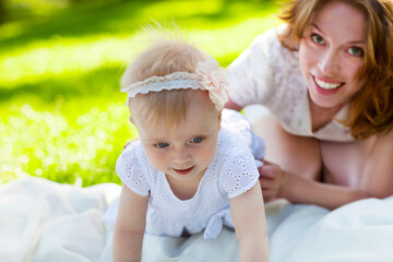 Happy mum and her Child playing in Park together