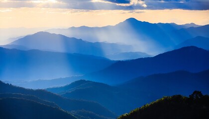 beautiful landscape of blue mountains layers during sunset with sunrays