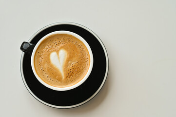 A cup of heart-shaped latte coffee