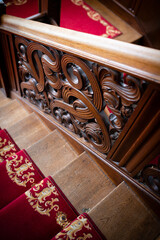 Ornate carved wooden staircase.