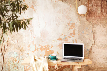 Photo camera and coffee near laptop in creative studio
