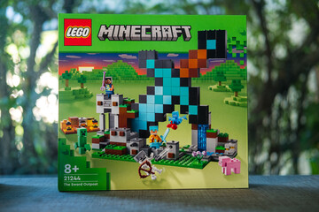 Fototapeta premium Bangkok, Thailand - January 9, 2024 : A green box of LEGO Minecraft The Sword Outpost 21244. Characters of the game Minecraft. LEGO is a Danish toy production company based