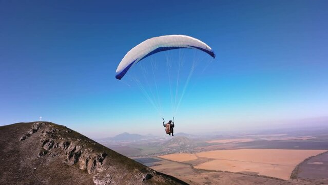 Aerial view. Chasing a hang glider in the air. Unique aerial photographs of extreme sports shot on a sports fpv quadcopter