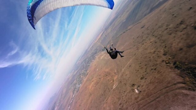Aerial view. Chasing a hang glider in the air. Unique aerial photographs of extreme sports shot on a sports fpv quadcopter