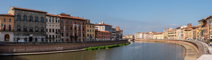 Fototapeta na wymiar Old picturesque houses at the Arno river waterfront in Pisa