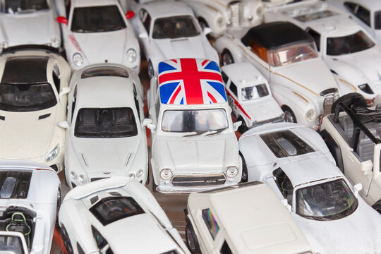 Collection of white model cars with a Mini Cooper with British flag on top in Deventer, The Netherlands on August 8, 2023