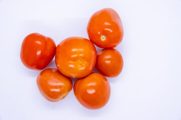 Red shiny fresh tomatoes in isolated White Background
