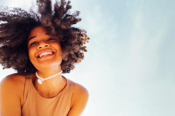 Close up portrait of happy african american female teenage smiling sweetly at the camera