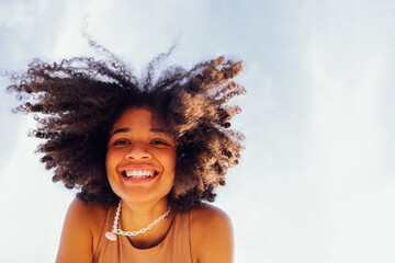 Close up portrait of happy african american female teenage smiling sweetly at the camera
