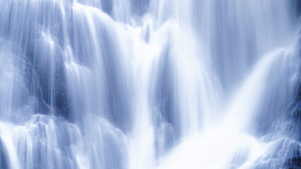 Long exposure shot of cascade waterfalls detail, white toned image with beautiful and dreamy...