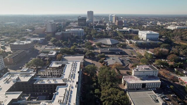 Drone shot and aerial view of downtown state capitol, government buildings, college town, tall buildings, and highrises in the city of Tallahassee, Fl in Florida, United States