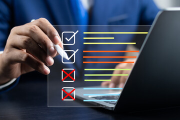 Business performance monitoring and evaluation concept, Take an assessment, Business man using laptop and tablet online checklist survey, Filling out digital checklist, Questionnaire with checkboxes. - obrazy, fototapety, plakaty