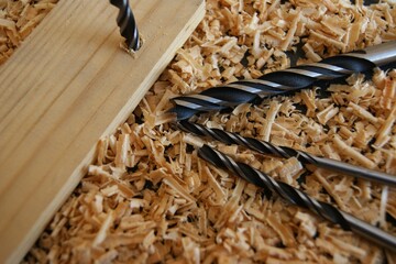 Drills in wood shavings in a carpenter's workshop. High quality photo