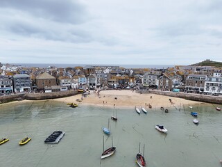 Small beach in harbour St Ives Cornwall on calm summers day drone,aerial