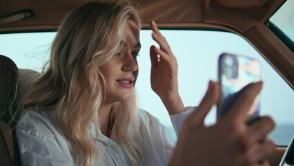 Girl speaking online meeting telephone sitting car closeup. Woman talking camera