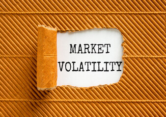 Market volatility symbol. Concept words Market volatility on beautiful white paper. Beautiful brown paper background. Business market volatility concept. Copy space.orange