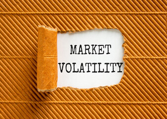 Market volatility symbol. Concept words Market volatility on beautiful white paper. Beautiful brown...