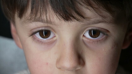 Close up of child's eyes staring at camera captured with macro lens. Young boy eye sight